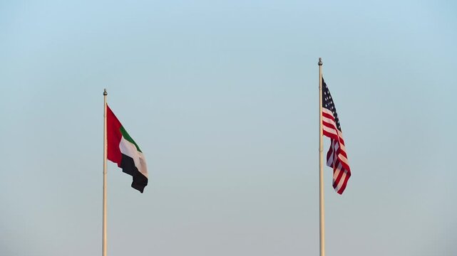 USA and UAE flags are blown in the wind