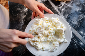 Making the filling for varenyky, mixing the cottage cheese with a fork. Step-by-step photo series...