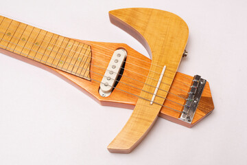 Electric slide guitar made of different types of wood on a white background
