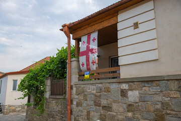 Georgian flag hangs on a house in Mtskheta