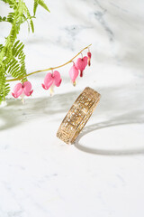 Gold Filigree Bracelet with Bleeding Heart Flowers on Marble
