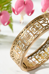 Gold Filigree Bracelet with Bleeding Heart Flowers on Marble
