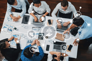 Top view analyst team utilizing BI Fintech to analyze financial data at table in meeting room. Analytic BI dashboard power on paper for business insight and strategic marketing planning. Prudent Amity
