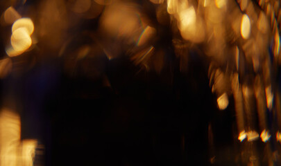 Abstract light leaks on black background with copy space. Studio lens flare bokeh effect.