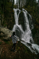 Tourist at the Keivu waterfall, Krasnaya Polyana, Sochi.