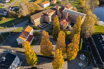 Beautiful view of colorful autumn trees and river on sunny day, aerial drone perspective