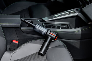 Handheld Car Vacuum Cleaner Resting in a Car Interior © eugenivy