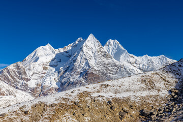 Mera Peak high altitude mountain summit ascent in Himalayas. Stunning views above the clouds at sunrise from the top of the mountain. Alpine route climbing on the snow path in Himalayas