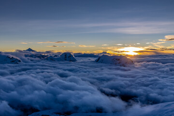 Mera Peak high altitude mountain summit ascent in Himalayas. Stunning views above the clouds at sunrise from the top of the mountain. Alpine route climbing on the snow path in Himalayas