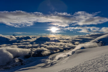 Mera Peak high altitude mountain summit ascent in Himalayas. Stunning views above the clouds at sunrise from the top of the mountain. Alpine route climbing on the snow path in Himalayas
