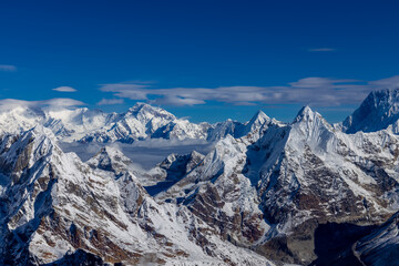 Mera Peak high altitude mountain summit ascent in Himalayas. Stunning views above the clouds at sunrise from the top of the mountain. Alpine route climbing on the snow path in Himalayas
