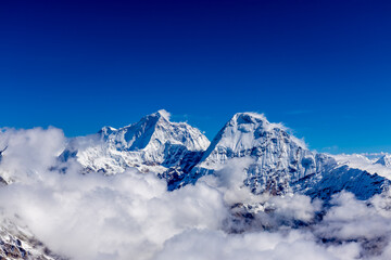Mera Peak high altitude mountain summit ascent in Himalayas. Stunning views above the clouds at sunrise from the top of the mountain. Alpine route climbing on the snow path in Himalayas