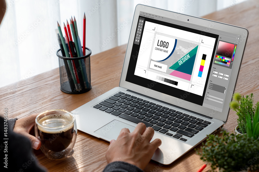 Poster graphic designer software for modern design of web page and commercial ads showing on the computer s