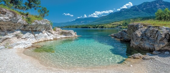 Serene beach cove with crystal-clear water, nestled between rocky shores and majestic mountains under a bright summer sky