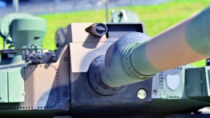 Heavy military tank vehicle turret gun aiming on a target and ready to fire. The rotating turret...