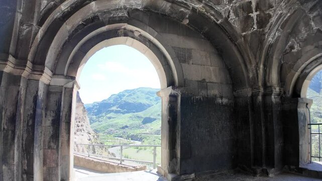 Sunlight streaming through ancient arches of the Vardzia cave monastery reveals a stunning landscape, highlighting the architectural and natural beauty of this 12th-century site in Georgia