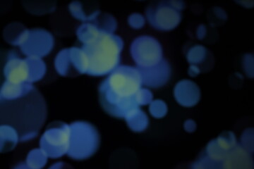Christmas lights in bokeh. Outside in December. Snow and blue bokeh on a black background, bokeh abstract background, modern technological abstract background. Blue Christmas background, Xmas bokeh 
