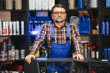 Salesman standing at the counter in auto parts store
