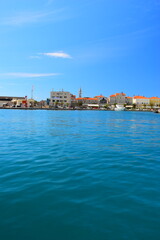 Obraz premium Budva, Montenegro - May 04, 2024: Dukley Marina and Old Town. The old city walls of Budva along the Adriatic coast, Montenegro. On a hot, sunny, spring afternoon.