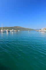 Obraz premium Tivat Montenegro 05052024 A walk through the luxury marina Porto Montenegro, luxury houses, luxury yachts, vacation at sea. On a hot, sunny, spring afternoon. 