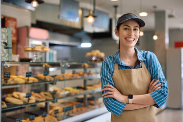 Successful female bakery owner looking at camera.