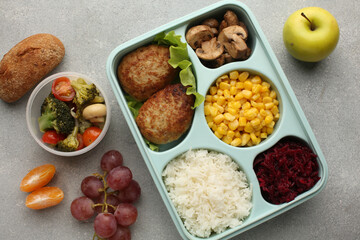 Healthy diet. Different meals in containers and products on Grey background, flat lay. Diet and calorie counting Space for text