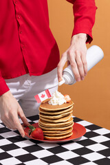 Canada Day traditional food concept. A girl in a classy cafe eats in Canada. Breakfast and lunch.