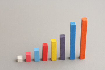 Colorful bar graph with arrow pointing upwards. Business, market growth and progress concept.