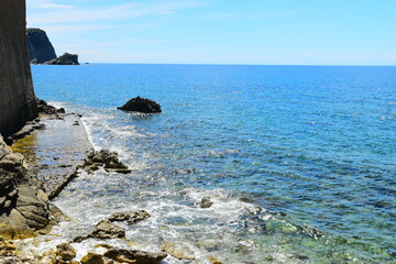 Budva, Montenegro - May 04, 2024 : The Old Town Fortress in Budva. A stone wall on the shore of the Adriatic Sea in Montenegro. Horizontal. On a hot, sunny, spring afternoon.
