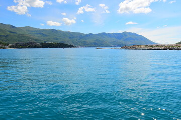 Budva, Montenegro - May 04, 2024: Dukley Marina and Old Town. The old city walls of Budva along the Adriatic coast, Montenegro. On a hot, sunny, spring afternoon.