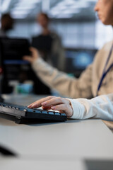 Technician in server room typing on keyboard, implementing power management solutions to reduce...