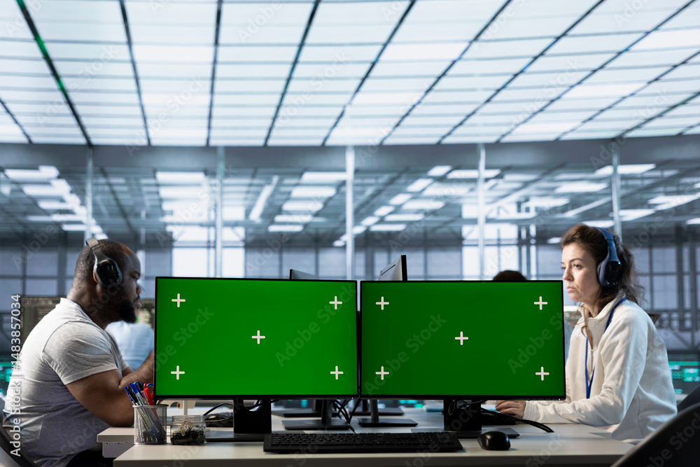 Poster technicians in data center listening music, optimizing it infrastructure using green screen pcs. ser