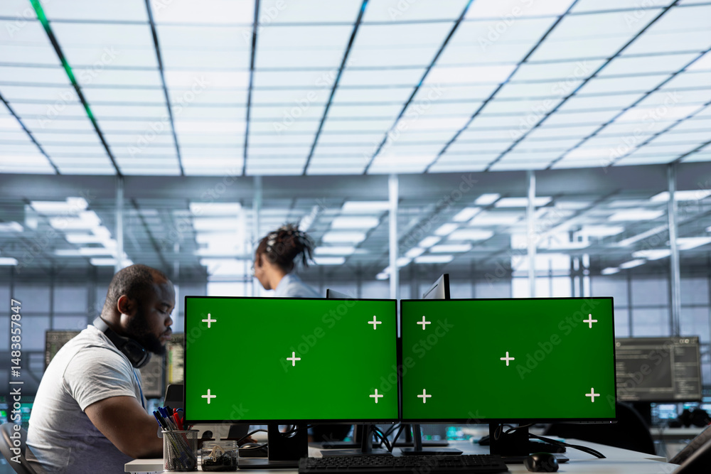 Poster data center employees using isolated screen multi monitor pc setup to write disaster recovery plans 