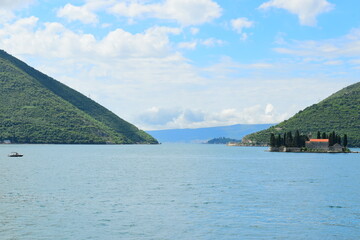 Obraz premium PERAST, MONTENEGRO - May 06, 2024: Village Perast on coast of Boka Kotor bay. Montenegro. Adriatic sea. During spring on a sunny day.