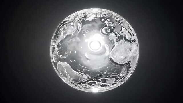 static video of a monochromatic glowing orb suspended in a dark void, its surface swirling with intricate silver patterns surrounded by a soft halo, perfect for minimalist and modern transitions