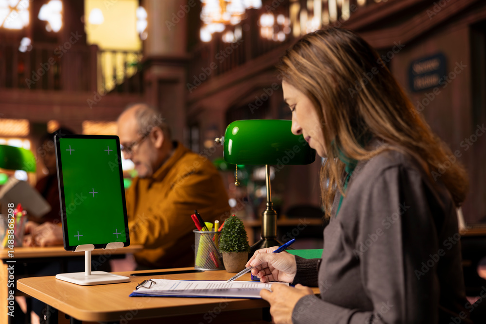 Poster mature focused student writes a transcript next to copy space display, review academic books and pre