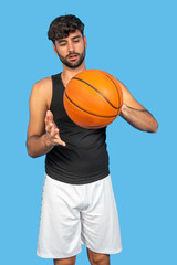 Fototapeta premium Young athlete skillfully spinning a basketball