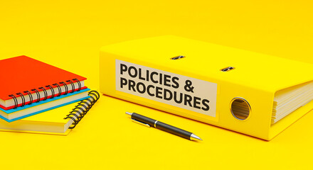 A yellow binder labeled policies and procedures with notebooks and pen on yellow background is visible