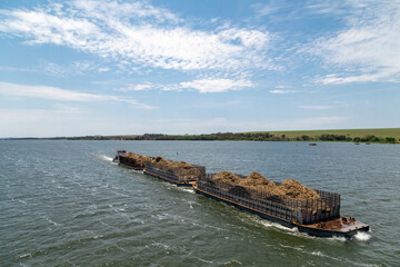 Brazilian ship carrying sugarcane bagasse, sugar cane on the Tiete river.