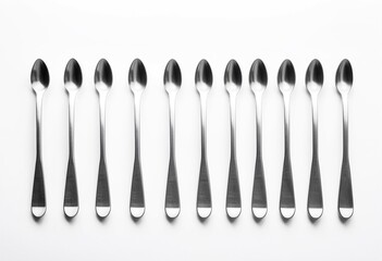 A row of spoons sitting on top of a white surface.