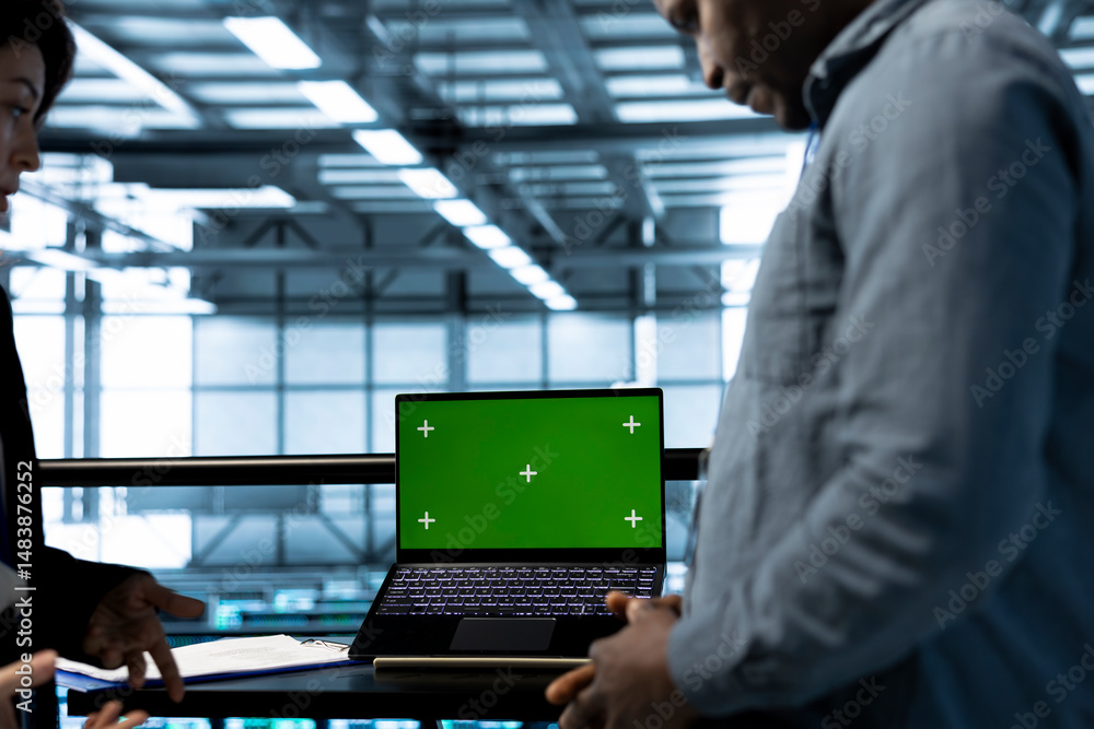 Poster teamworking coworkers in data center using automation tools on green screen mockup laptop. engineers