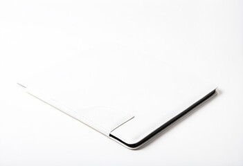 A white laptop computer sitting on top of a white surface.