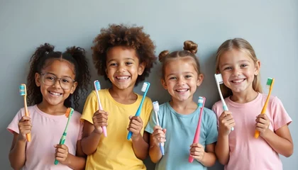Poster Group of children holding toothbrushes smiling. Happy kids care teeth, practice oral hygiene. Dental health, healthy smile, teeth brushing education. White background, kids smile.