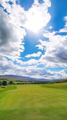 A golf course with a green hill in the background. The hill is covered in grass and has a golf hole at the bottom