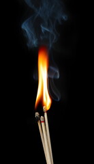 Matchstick ignite burning bright fire flame and smoke isolated on black, clipping