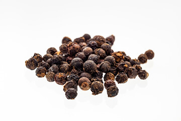 Black peppercorns on white background - Piper nigrum