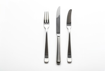 A knife, fork and spoon on a white surface.