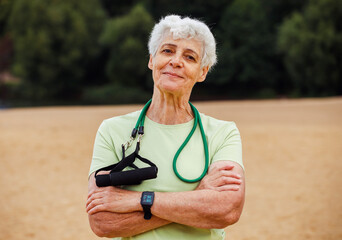 Elderly woman with short hair wear sportswear with resistance rubber bands. Healthy lifestyle, active retired life.