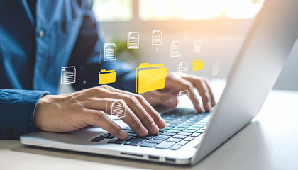 Person efficiently managing digital files on a laptop