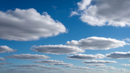 Beautiful bright blue sky displaying fluffy white clouds on a sunny day in nature